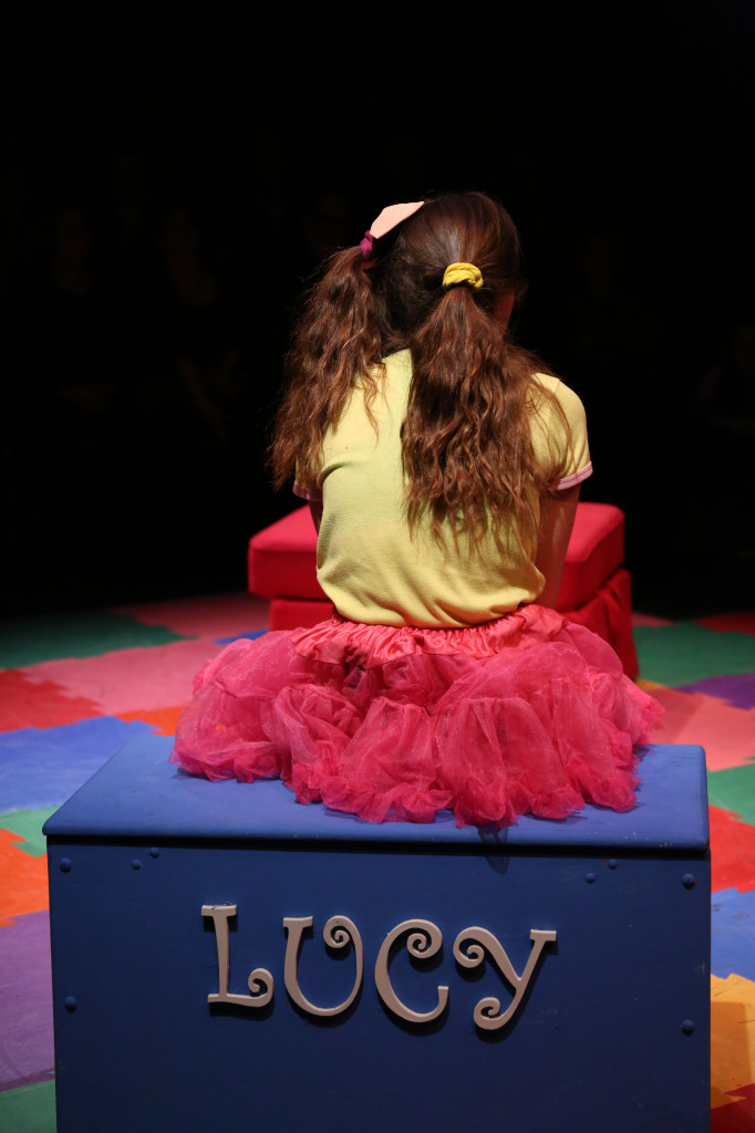 Photo by Jacob Cader: Sarah Sugg (VI), sitting on her toy chest as the character “Lucy”